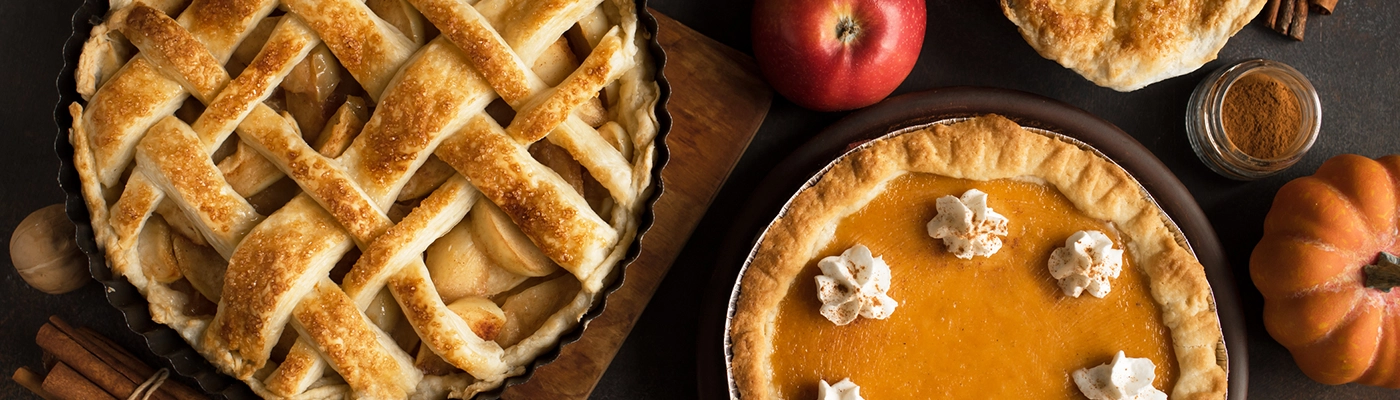 pumpkin and apple pie on a table